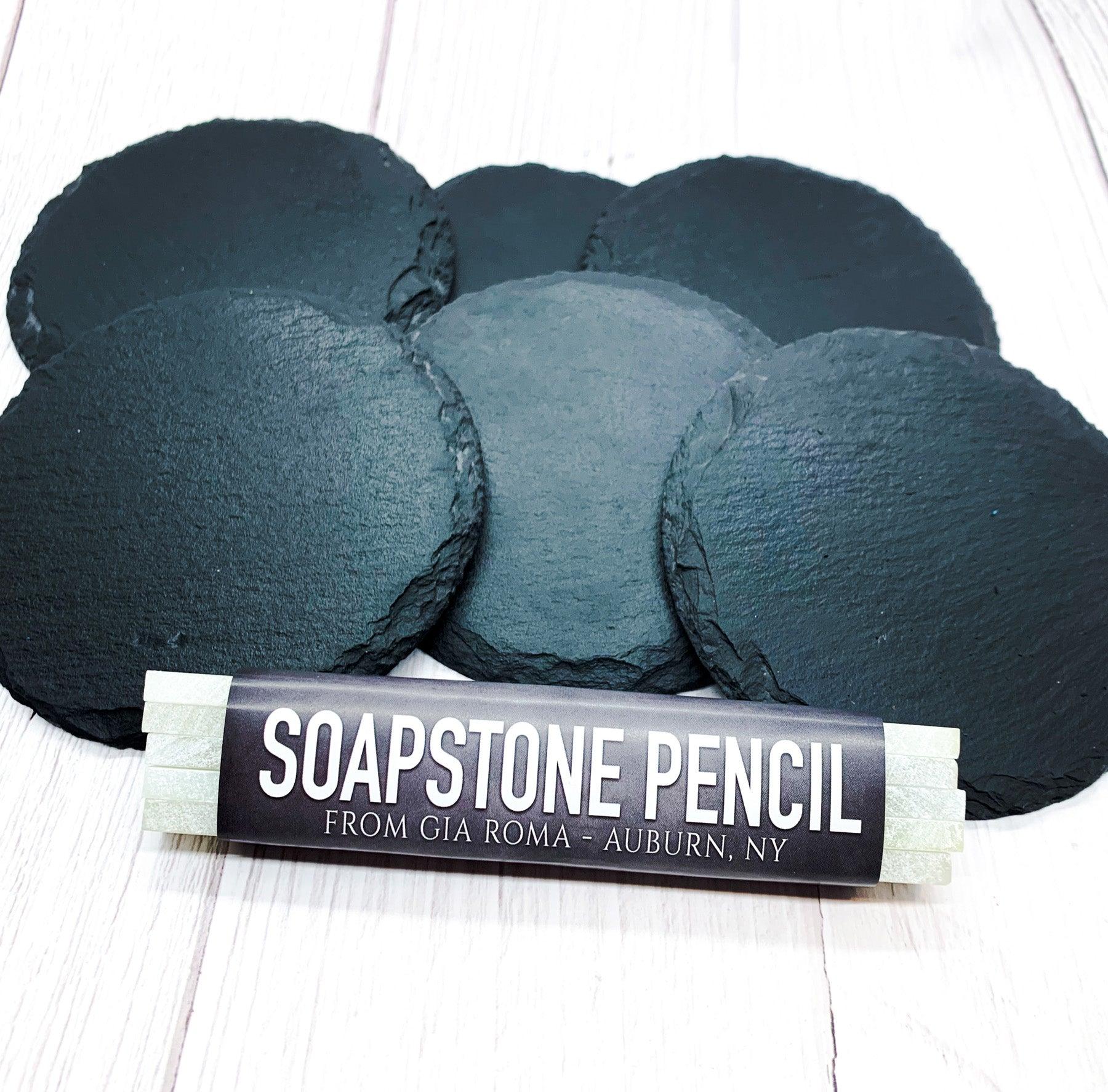 Stack of four dark gray natural slate coasters with rustic raw edges and unique stone textures photographed on a crisp clean background.
